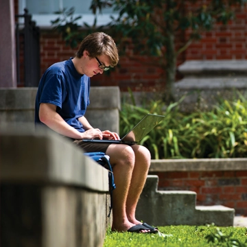 Student with laptop outside, Tulane University