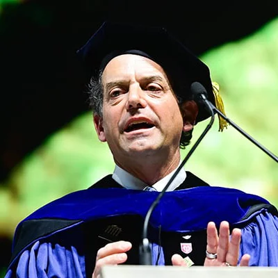 Dean Brian Edwards, speaking at a podium with microphone at Tulane University