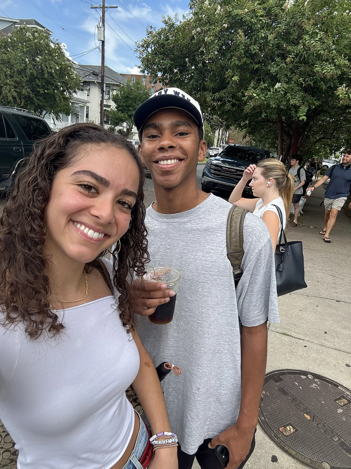 Zoraya and Wesley smiling together outdoors on their way to breakfast