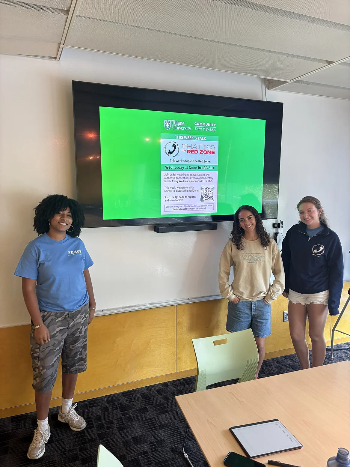 Zoraya and two fellow students at a Community Table Talks session