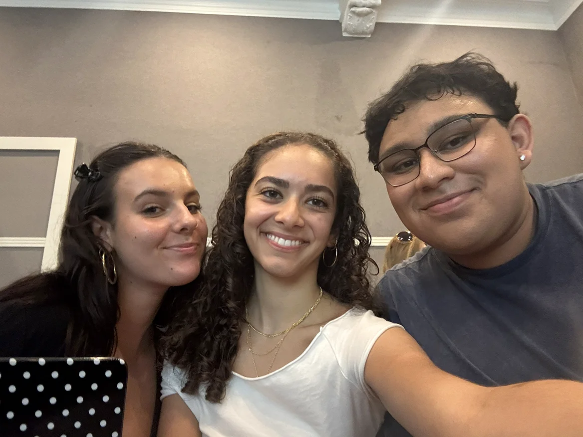 Zoraya smiling with two classmates
