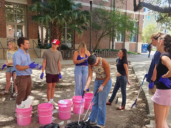 Tulane students Approaches to Environmental Studies waste audit on a sunny campus day.
