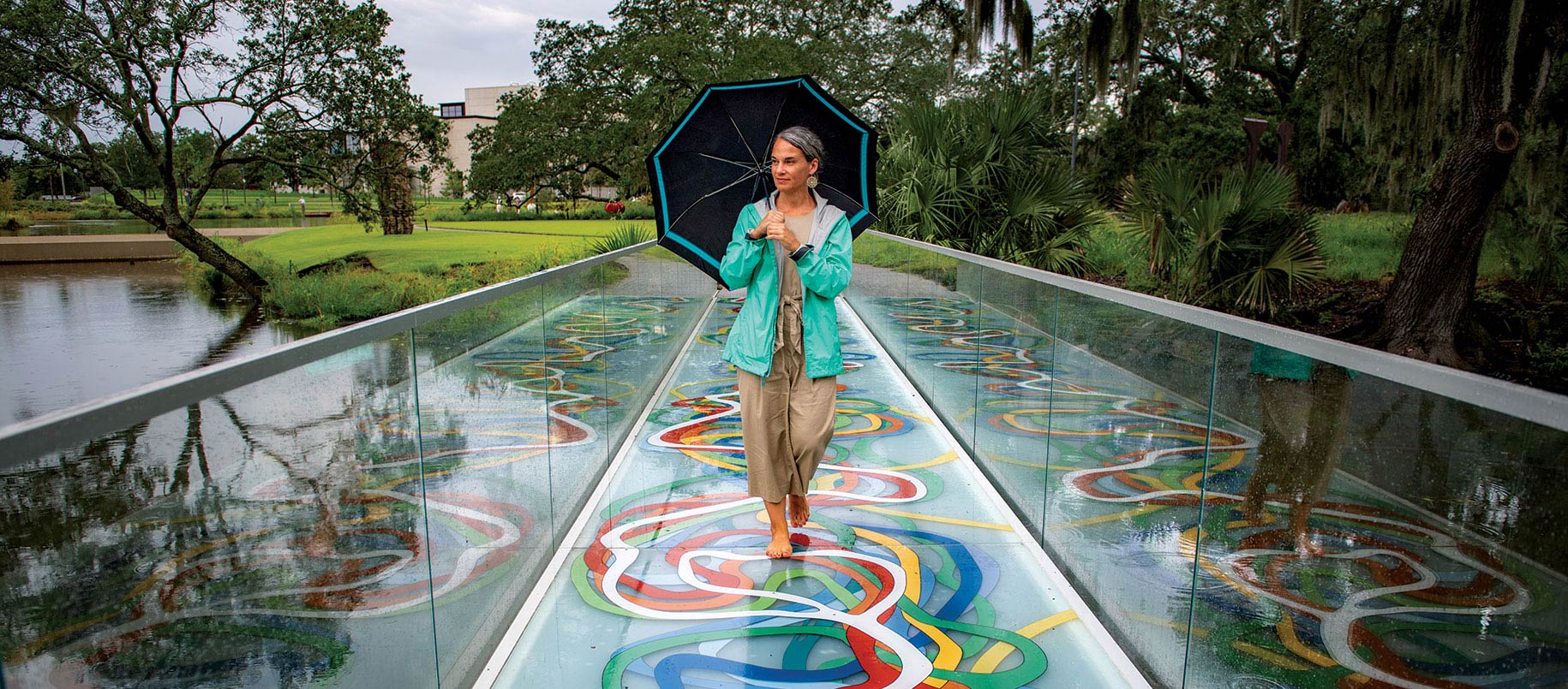 NOCGS director Rebecca Snedeker walks along artist Elyn Zimmermans installation Mississippi Meanders