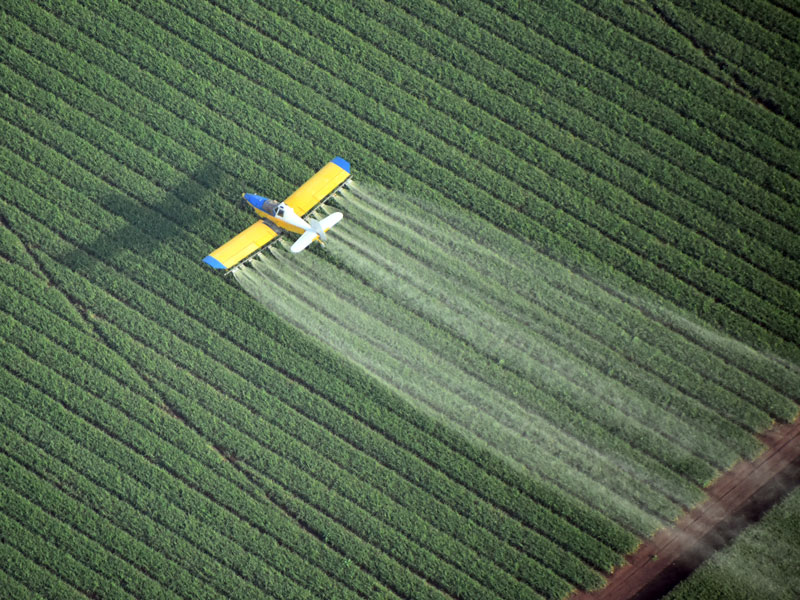 Ag plane spraying crops