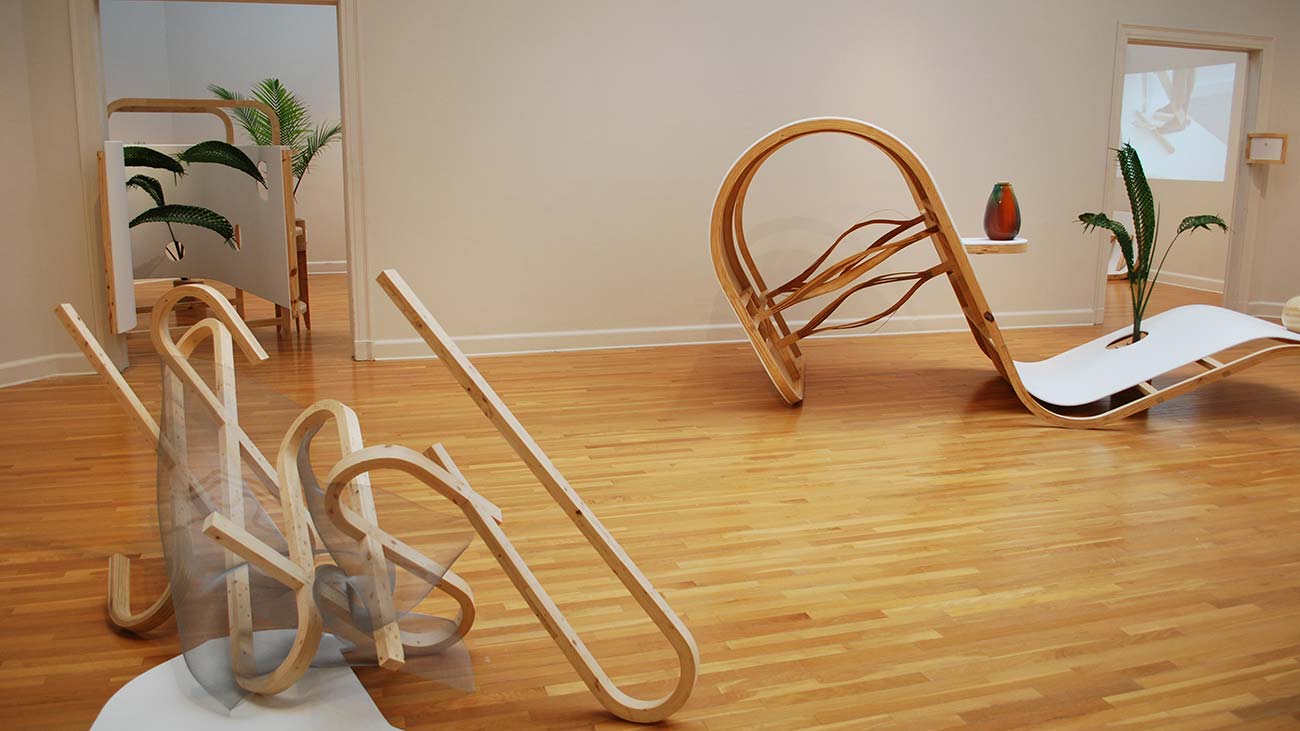 image of gallery interior with bent wood sculptures by Blas Isasi that incorporate plants