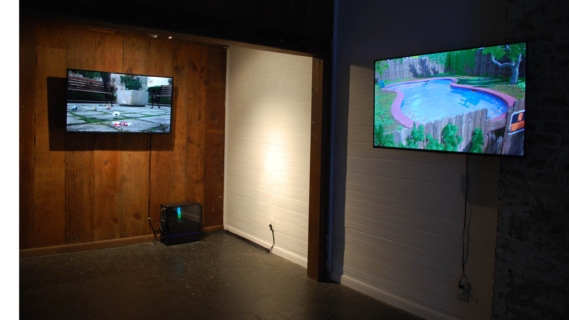 view of two video installations in panelled gallery of The Front