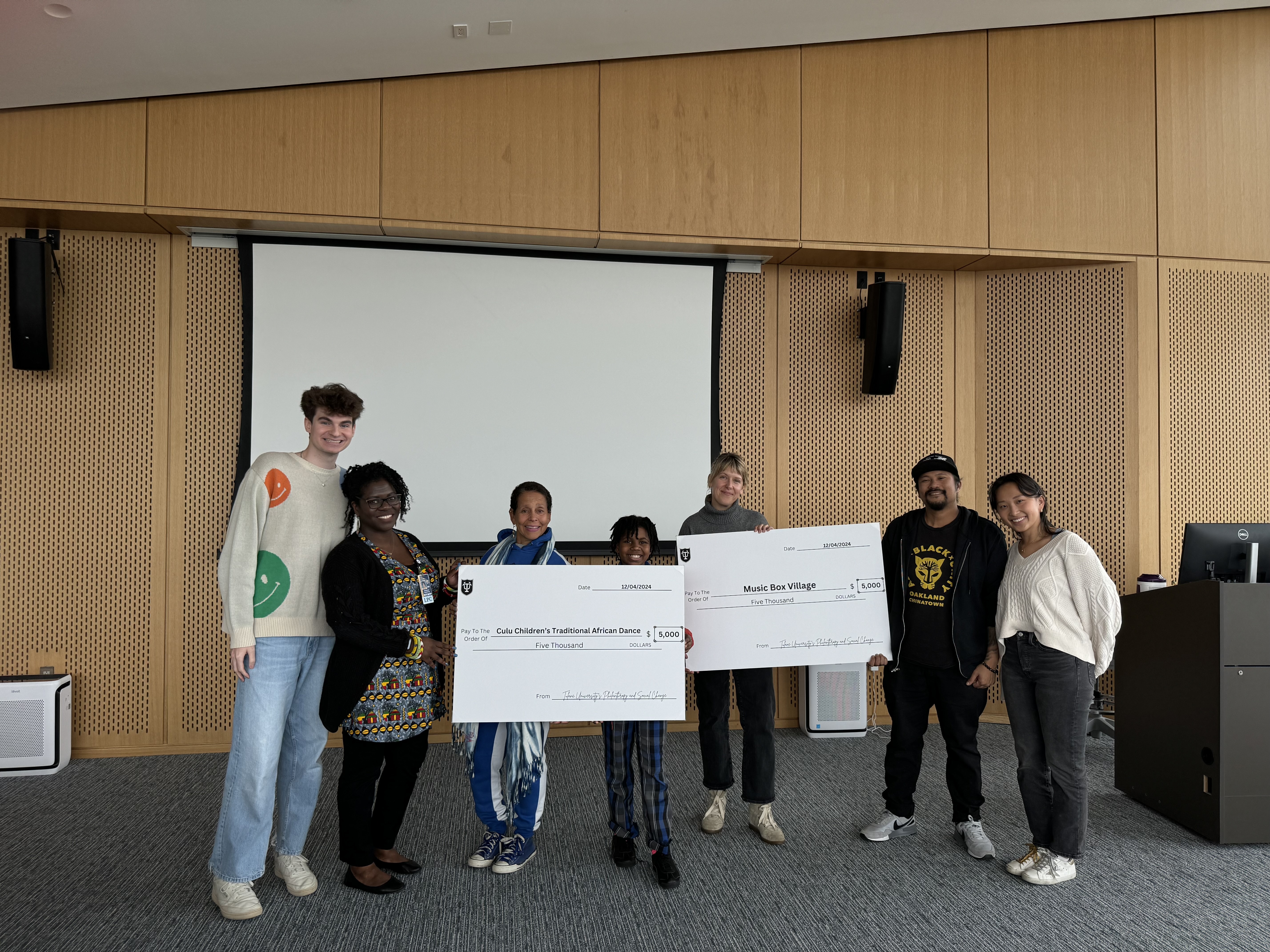 Philanthropy & Social Change Students present grant recipients with checks at the awards ceremony