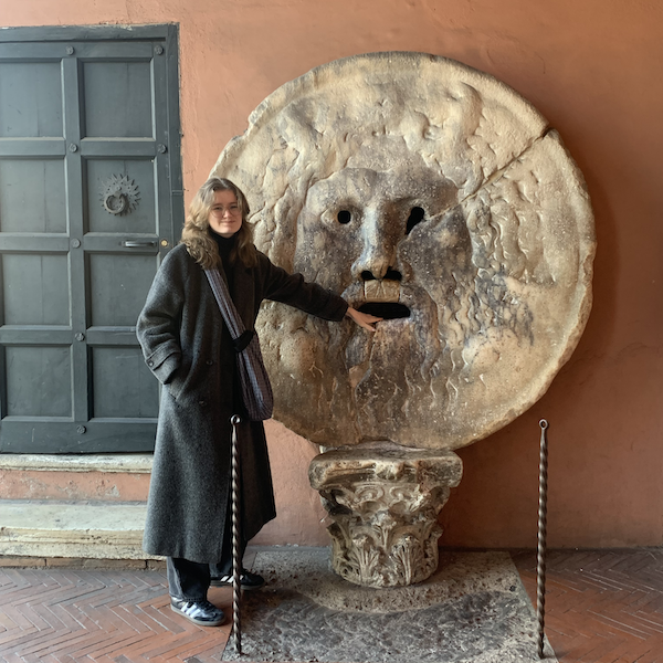 Person standing next to statue