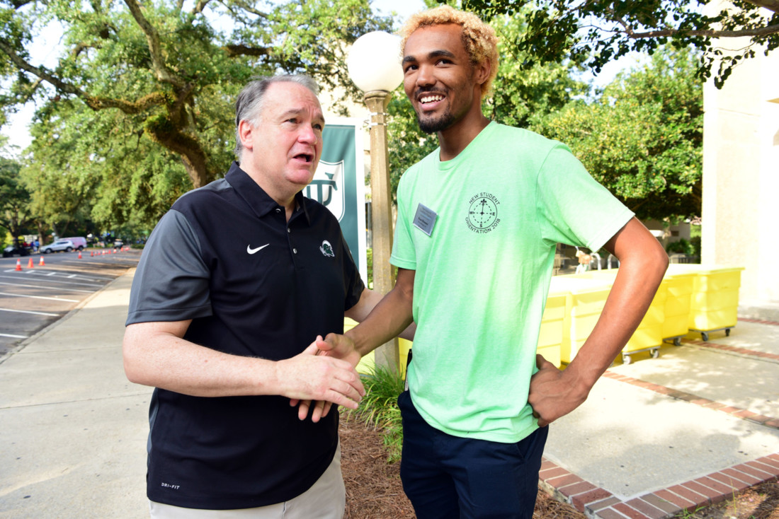Tulane President Mike Fitts speaks with student Wave Leader and Director Evan Doomes