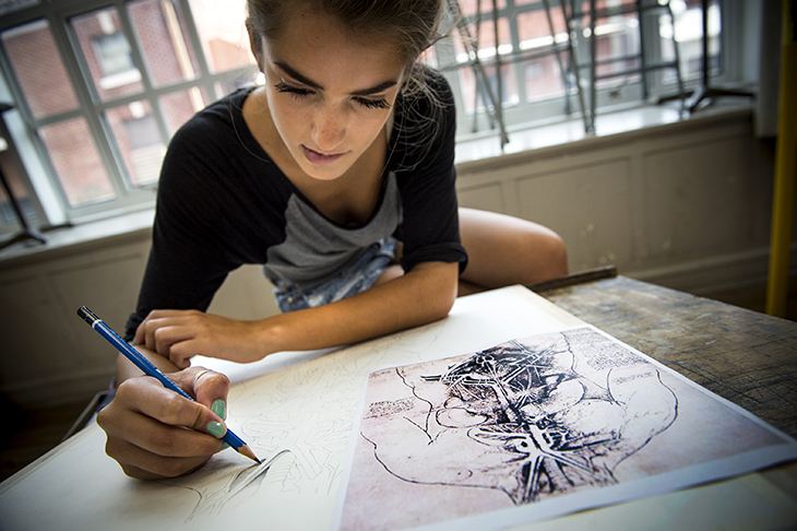 Senior Elizabeth Feroze works her pencil on a rendering of an anatomy study