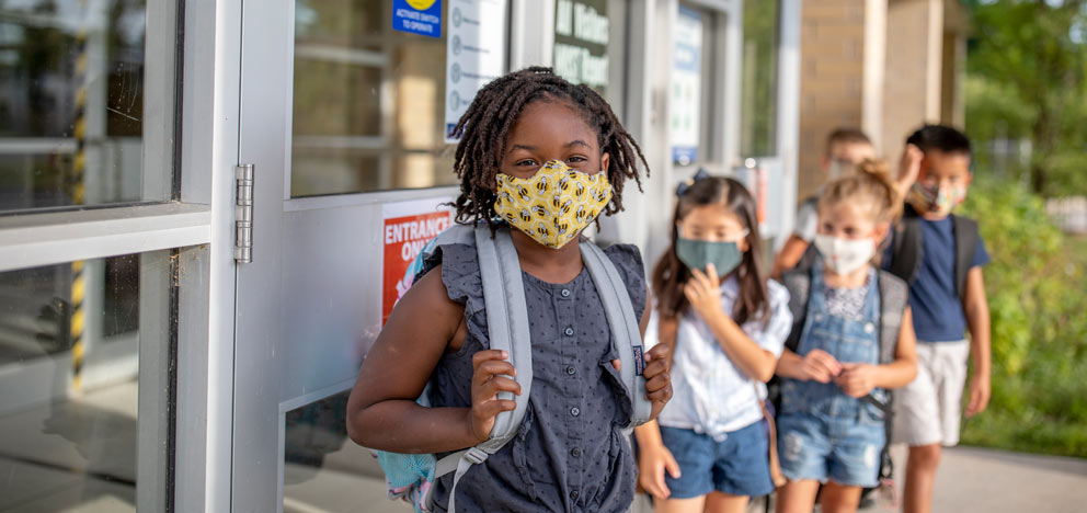 School children wearing surgical masks