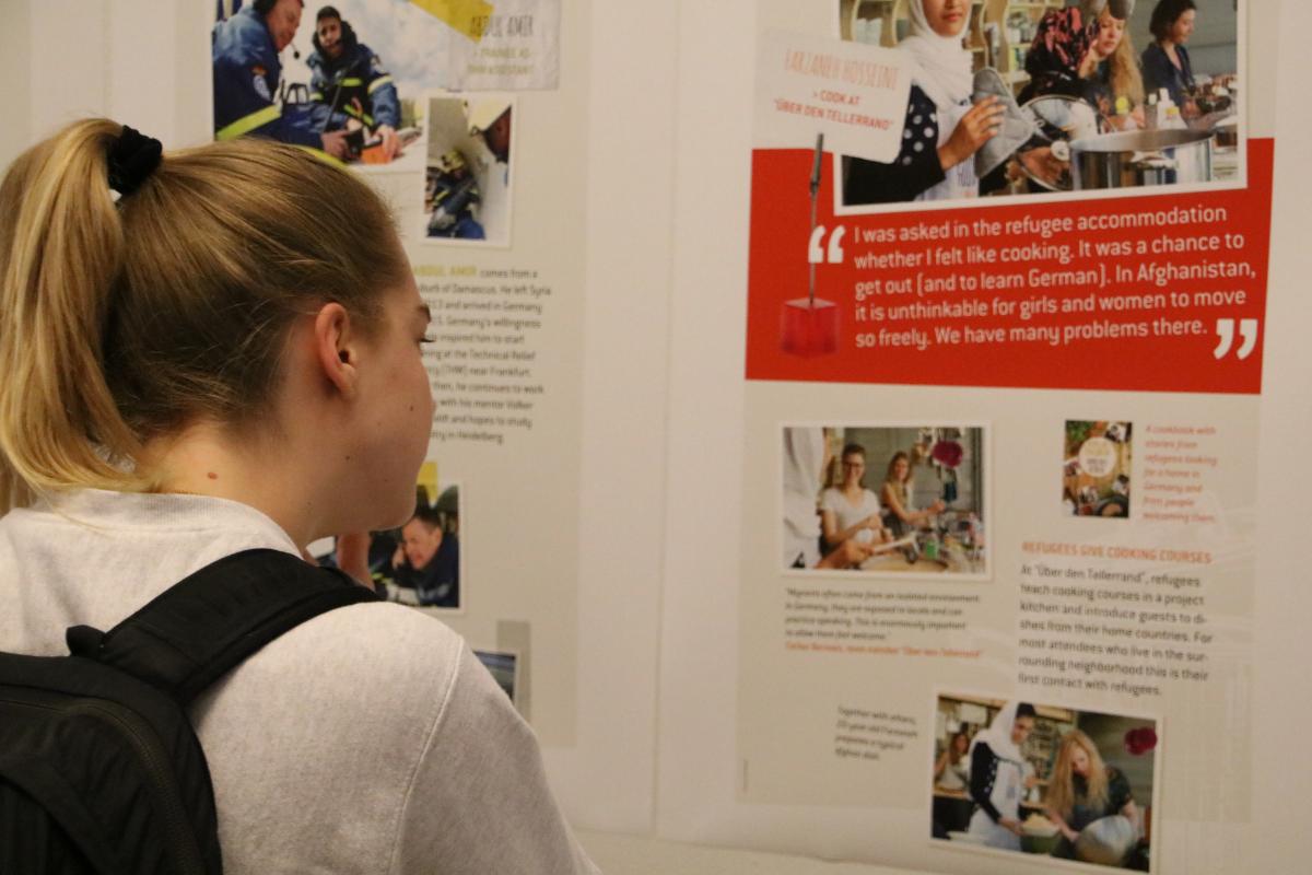 A student takes in the Integrating Immigrants exhibit