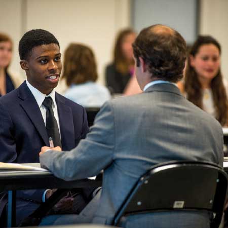 Confident Student talks with potential employer