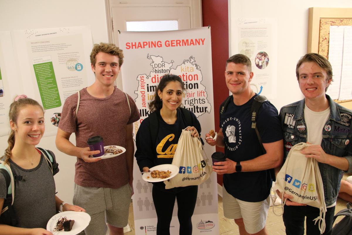 Students Enjoying Cake and Strudel at the Integrating Immigrants Exhibit