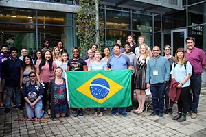 Students, faculty and staff gather around the Brazilian flag in recognition of its 4 million slaves.