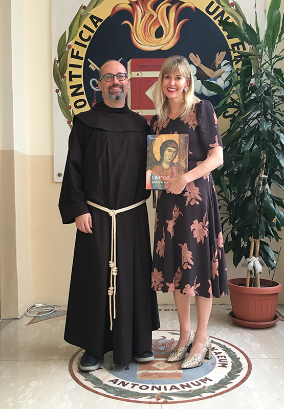 Holly Flora accepts the Premio San Francesco presented by Father Marco Guida in Rome