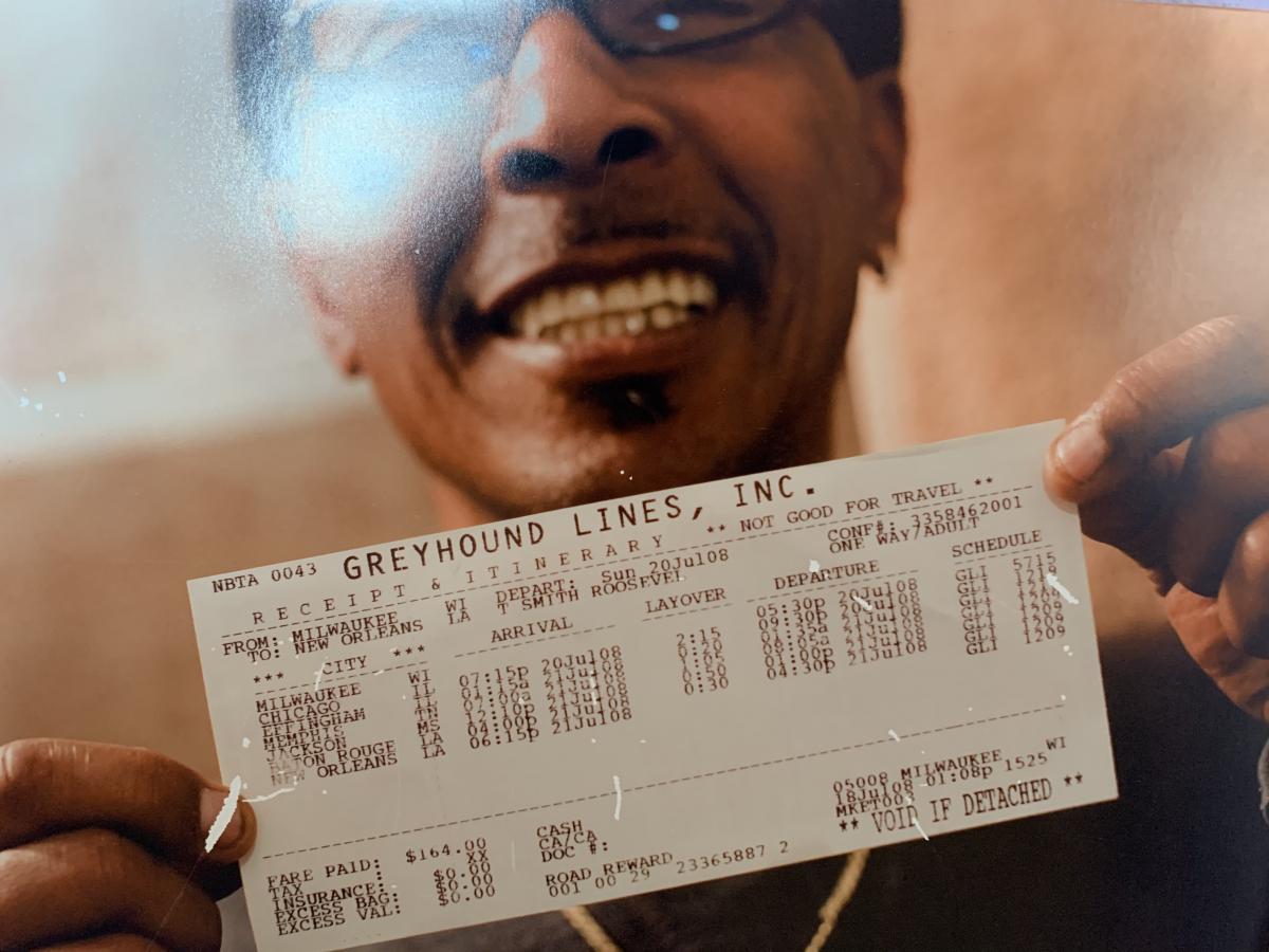 Man proudly showing his return ticket back home to New Orleans