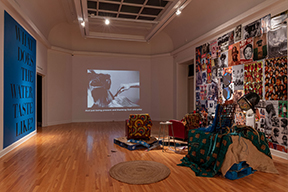 view of front room of Carroll Gallery with video projection and beauty chair