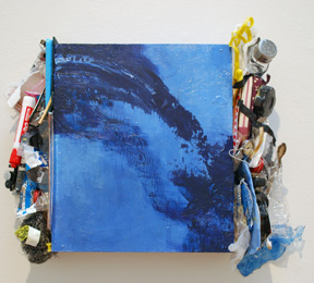 blue square panel with used oil paint tubes attached to left and right sides