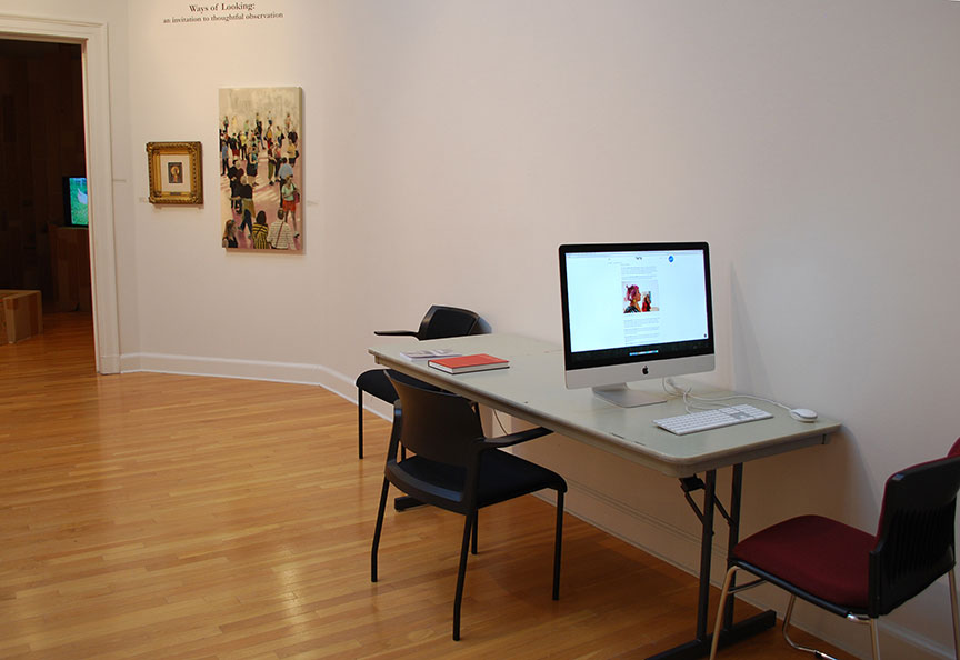 Table with books and monitor in gallery