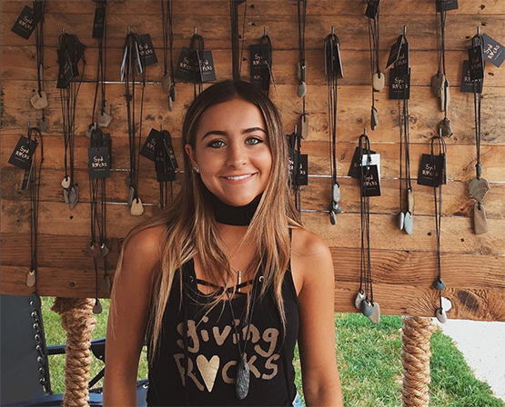 Sydney Martin showing off jewelry from her Giving Rocks Foundation