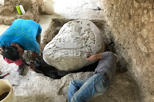 Marcello A. Canuto and team member with altar they discovered in the jungles of northern Guatemala