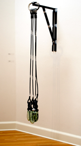 glass weights hung from long straps, attached to wall with bracket