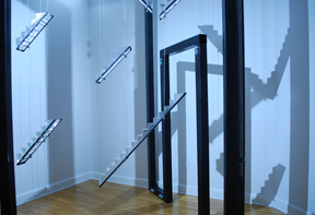 view of interior of rear gallery with suspended stair steps in cast glass and steel, with steel door frames