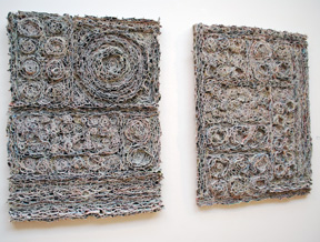 two vertical wall-hung pieces made of rolled and cut canvas