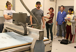 Students learning how to use a CNC machine, Tulane University