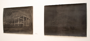pair of dark drawings pinned to wall with architectural features