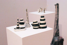 grouping of five black and white ceramic towers on pedestal