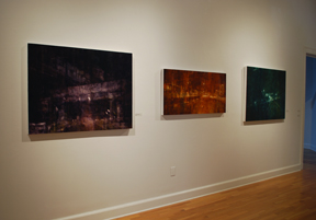 three paintings installed on wall