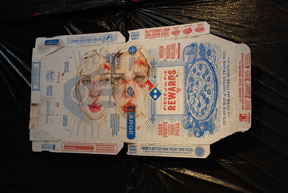 pizza box with painting of woman's face with bruises