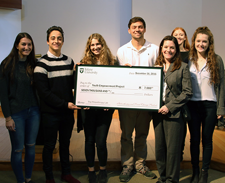 Students hold giant $7000 check