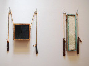 two wall-hung sculptures made of window frames and window weights