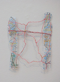wall-hung work of two facing figures connected by several red lines, created by carving out road maps