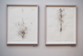 two vertical framed drawings created by smoke