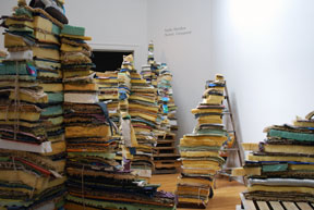 view of installation in gallery of stacks of multi-colored foam rubber