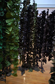 installation view of back gallery with dense hanging vine-like forms 