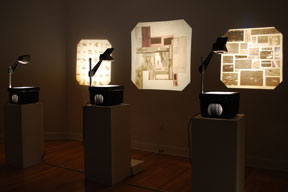 gallery installation view with three overhead projectors and projected images on the wall