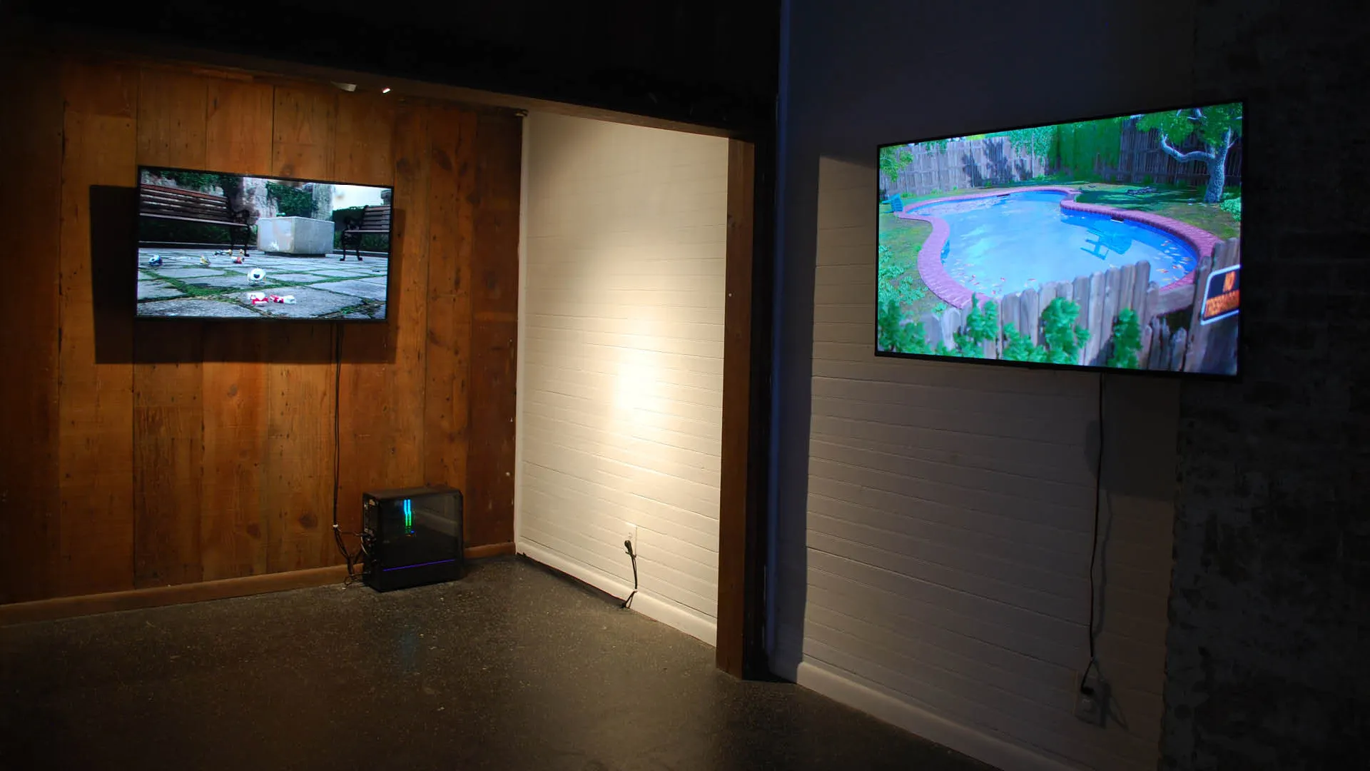 view of two video installations in panelled gallery of The Front