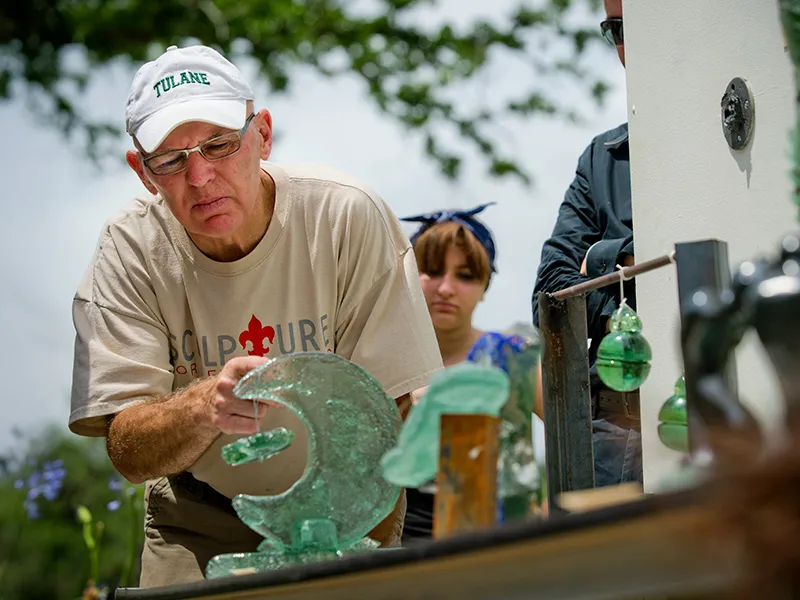 Tulane Studio Art Professor Gene Koss Closely Examines a Glass Sculpture During a Student Exhibition