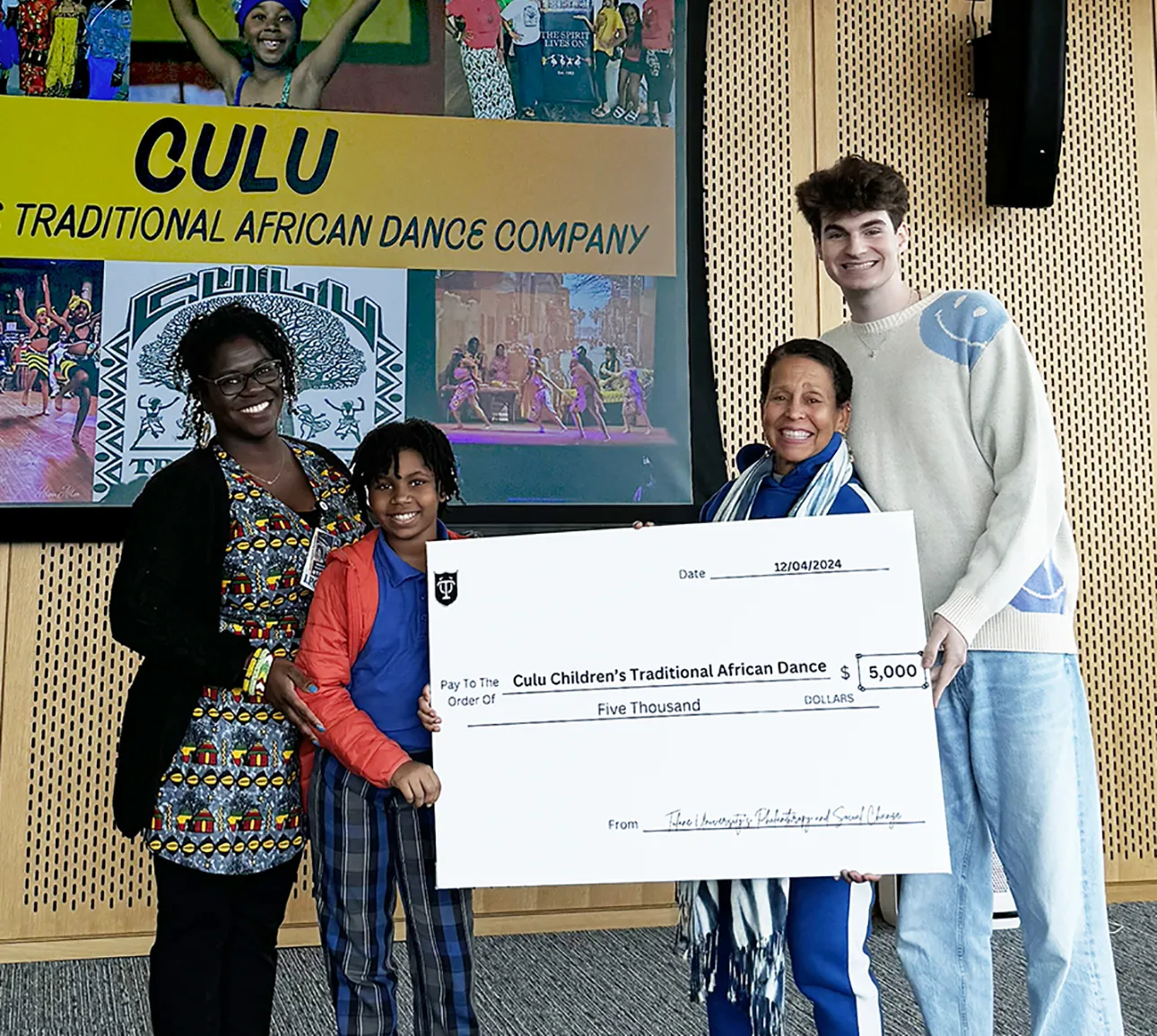 Philanthropy & Social Change students present grant check.