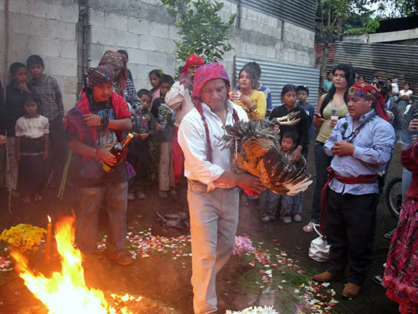 Tojil dancing the still live rooster around the fire. Ma Kikotem is on the side.