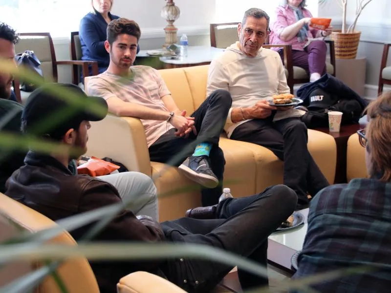 Richard Rudolph, right, speaks with students at Tulane University