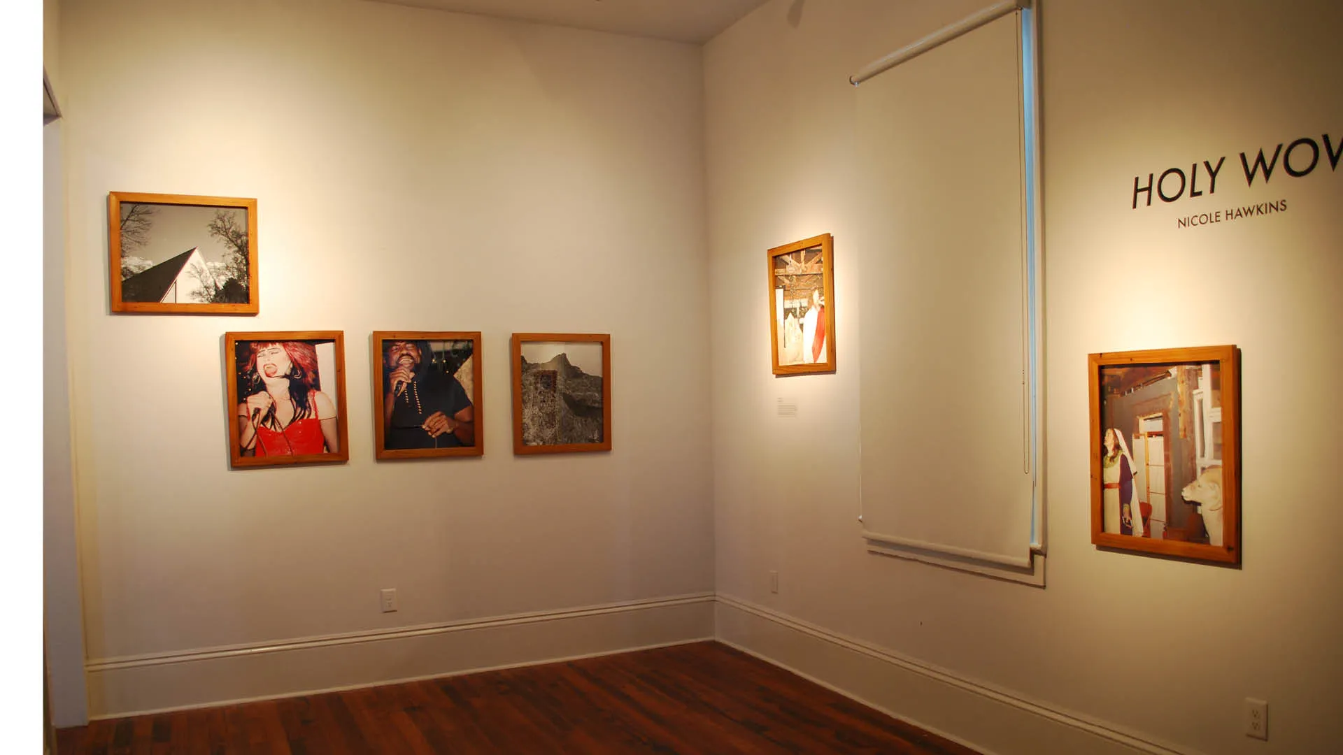 interior view of gallery with multiple framed photographs